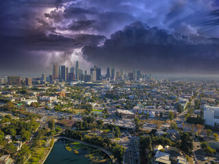 a breathtaking aerial shot of downtown Los Angeles with skyscrapers lush green trees, small...