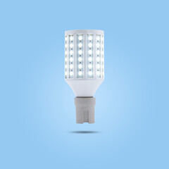 LED energy saving lamp 230v in a ceramic socket isolated on blue pastel color background.