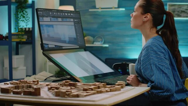 Woman working as architect looking at maquette on computer for construction layout and design. Engineer using touch screen monitor analyzing building model for architectural blueprint plan.
