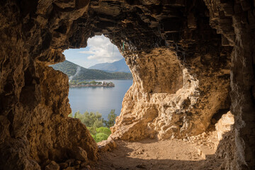 Look out from the small cave on the Mediterranean coast in Turkey - obrazy, fototapety, plakaty