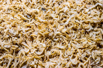 A pile of delicious dried shrimp fish inside of a seafood market close up