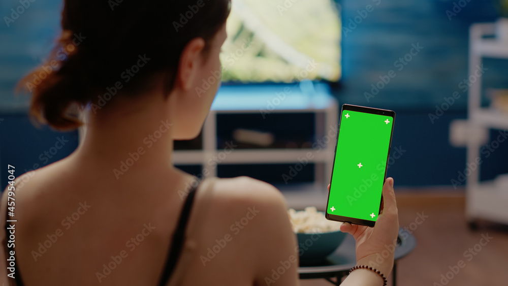 Poster young person with vertical green screen display on smartphone looking at isolated background media f