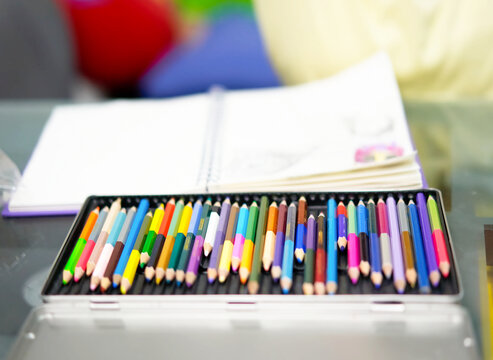 color pencil Crayons of various colors in a palette box, on the table
