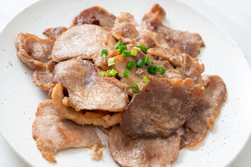 grilled pork neck sliced on plate