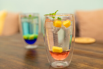 Two cold summer drinks, one red and one blue