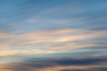Colorful sunset or sunrise in the sky. The sky and clouds are painted in different delicate colors.