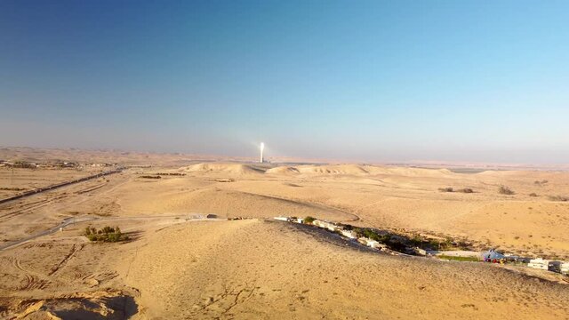 Flying from a long distance to direction of the solar power station Ashalim in Negev desert