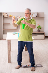Old man cleaning the house