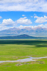 Green grassland and mountain natural landscape in Xinjiang,China.Beautiful prairie scenery.