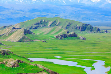 Fototapeta na wymiar Bayinbuluke grassland natural scenery in Xinjiang,China.Beautiful grassland and mountain with river landscape.