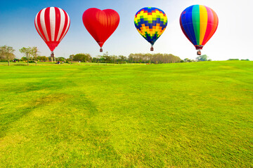 Hot air balloon over the green grass field