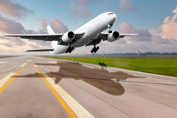 Fototapeta na wymiar Passenger airplane fly landing on runway in airport against sun rise