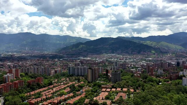 Drone Shot of the city of Medell&iacute;n, Colombia showing mountains and the city on a sunny cloudy afternoon.