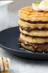 Pile of waffles stuffed with hazelnut close up.