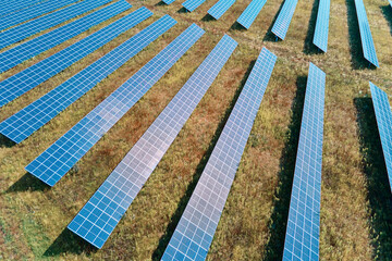 Row of solar panels in the field. Solar battery farm, aerial view. Alternative renewable energy concept