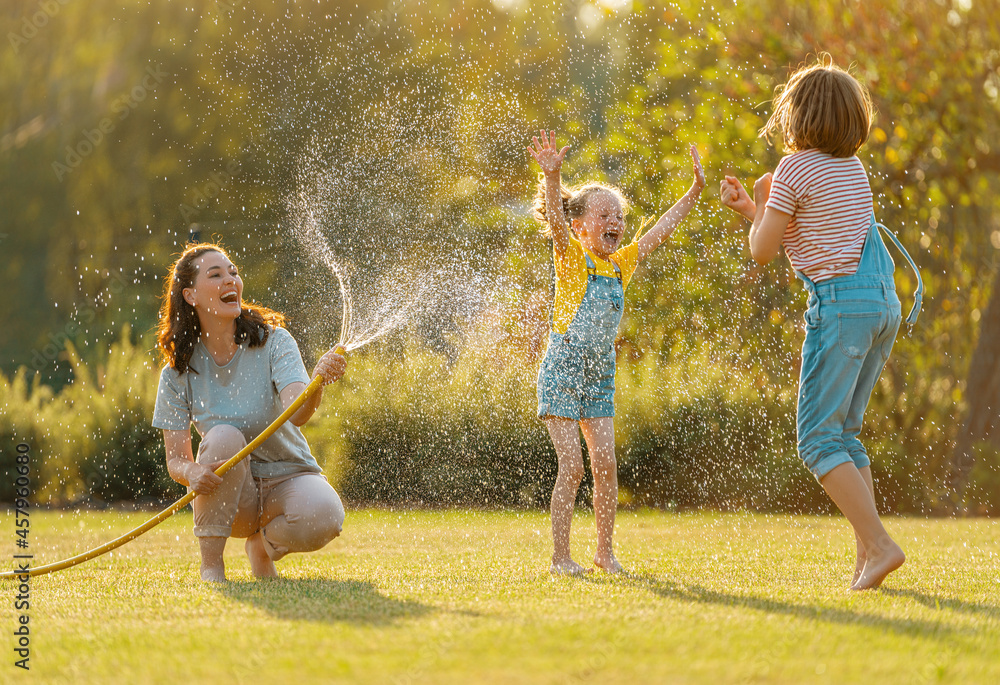 Wall mural Happy family playing in backyard