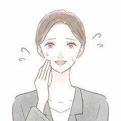 愛想笑いをするスーツを着た女性