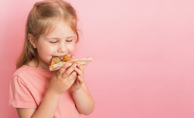 Little happy girl eating pizza close-up portrait on pink background.