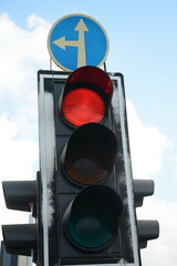 Red traffic light and Go straight or left sign. Mandatory signs. Road signs in Israel