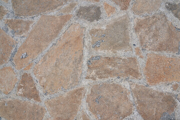 Orange old stone road surface. Seamless Texture. The texture of a stone road. High quality photo