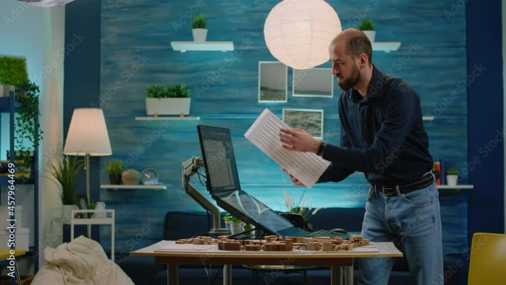 Poster architect looking at maquette and construction layout on table for architectural development. man en