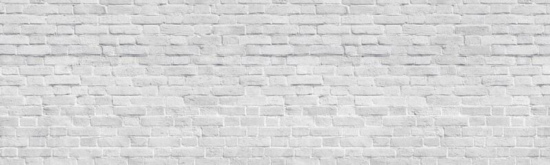 White old shabby brick wall wide panoramic texture. Light gray rough whitewashed brickwork...