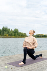 Close up on the hands of a woman sitting and meditating