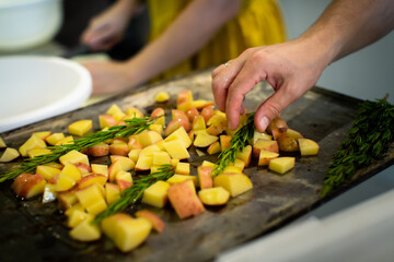 Potatoes on a baking pan before baking