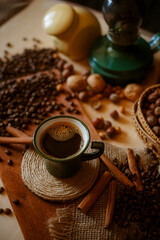 a cup of coffee on the background of coffee beans and cinnamon sticks