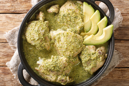 Guatemalan jocon de pollo with tomatillo sauce close up in the plate on the table. Horizontal top view from above