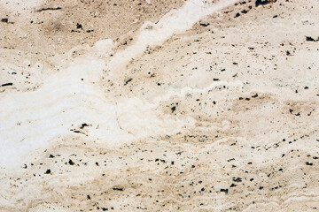 the texture of natural stone in a beige shade is similar to marble.
