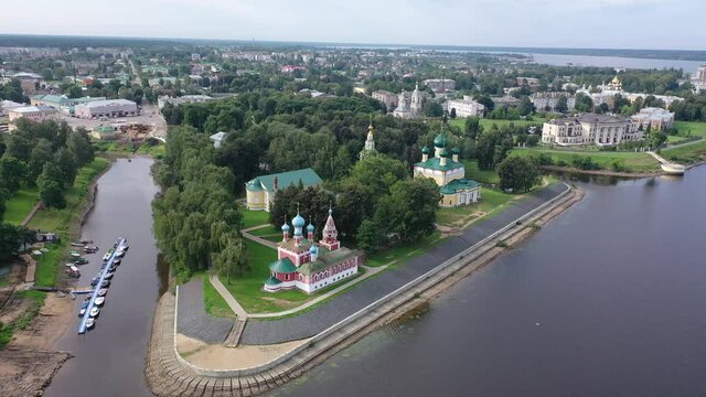 Summer aerial view of modern Uglich cityscape overlooking architectural complex of Kremlin with Transfiguration Cathedral and Church of Dimitry Tsarevich on bank of Volga, Russia