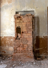 the interior of an abandoned Orthodox church, old damaged red brick stove