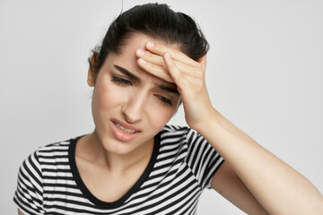 sick woman holding his head migraine depression light background