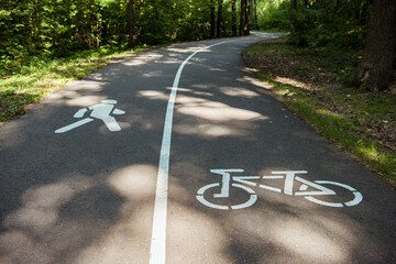 Bike lane, bike path and pedestrian signs in summer green park. Concept of rest and relaxation,...