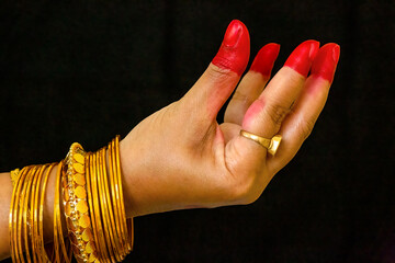 Woman dancer hand showing Kangula hasta depicting bell or fruits in Indian classical dance Bharata...