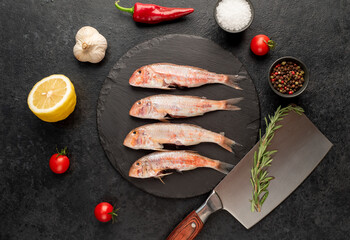 raw red mullet fish on stone background