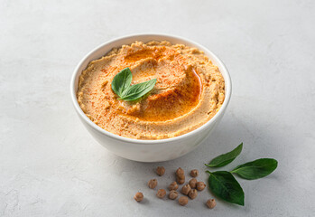 Oriental hummus with sesame, lemon and garlic on a gray background. Side view.