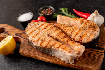 grilled salmon steak on stone background 