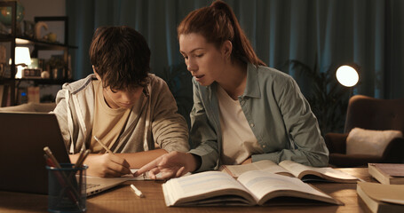 Tutor helping a student with his homework