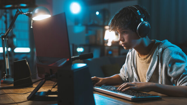 Boy play game on gaming PC online. Stock Photo