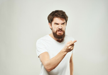 bearded man in a white t-shirt expressive look discontent Lifestyle