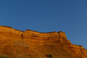 Geology. Desert landscape. Panorama view of the sandstone formation, the rocky cliffs, sand. Background or texture of sandy cliff on the coast, orange limestone