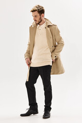 handsome man in beige coat look aside posing autumn style