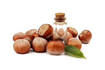 Hazelnut oil in glass bottle isolated on white background. Hazelnut background, healty food