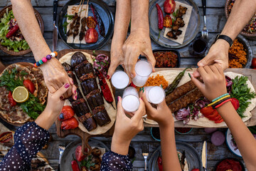 Fototapeta na wymiar Close up view of family members having fun and toasting with rakı 