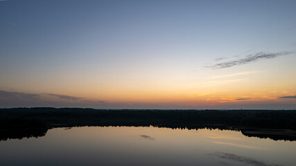 Fototapeta na wymiar Beautiful, colorful sky over a lake at sunset. Peaceful scene, no one in sight. . High quality photo