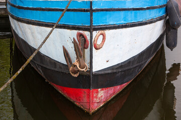 Bow of an old steel ship  moored in harbor in the Netherlands