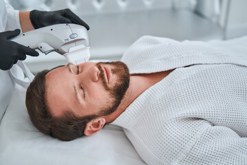 Patient napping during the ultrasound therapy performed by a dermatologist