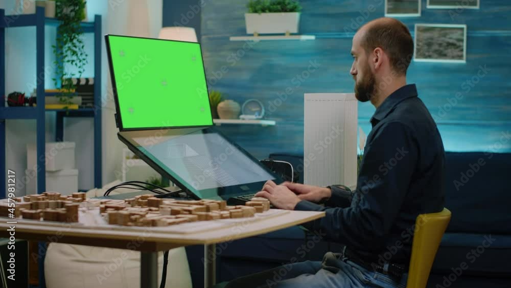 Aufkleber Man architect looking at horizontal green screen and using touch screen computer for building model. Engineer working with chroma key and isolated mockup template for development.